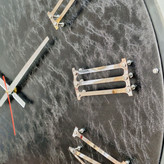 نمای نزدیک ساعت دیواری چرمی مشکی 60 سانتیمتری با اعداد رومی برجسته