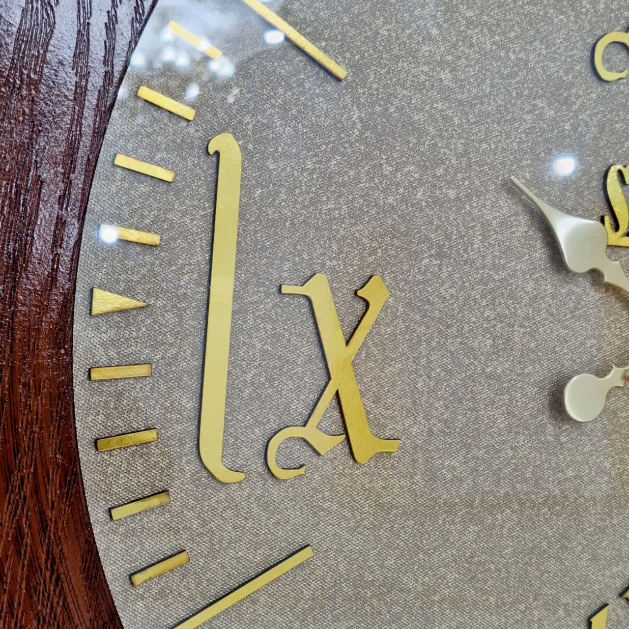 ساعت دیواری قهوهای 70 سانتیمتری چوبی با اعداد رومی طلایی نمای نزدیک اعداد دیگر